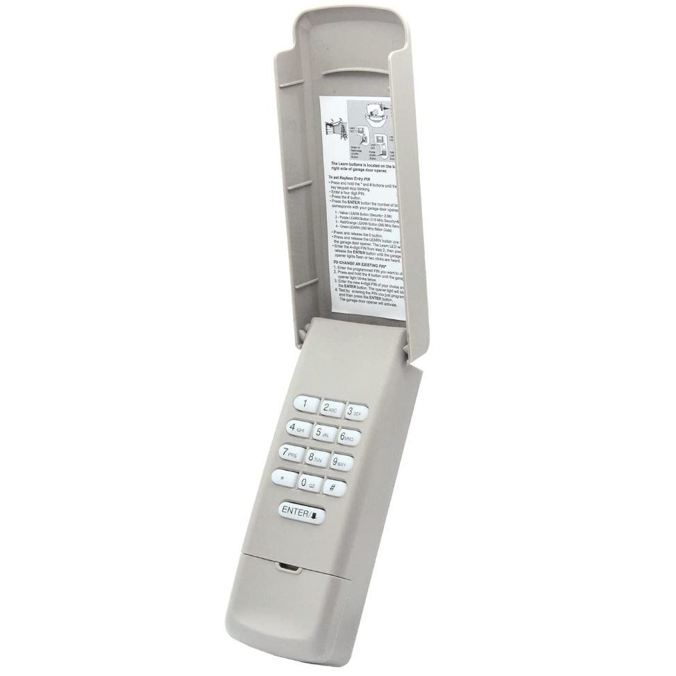 The wireless Gray Anderic 877MAX Keypad, compatible with Liftmaster openers, has a flip cover with numbered buttons and an inside instruction label.