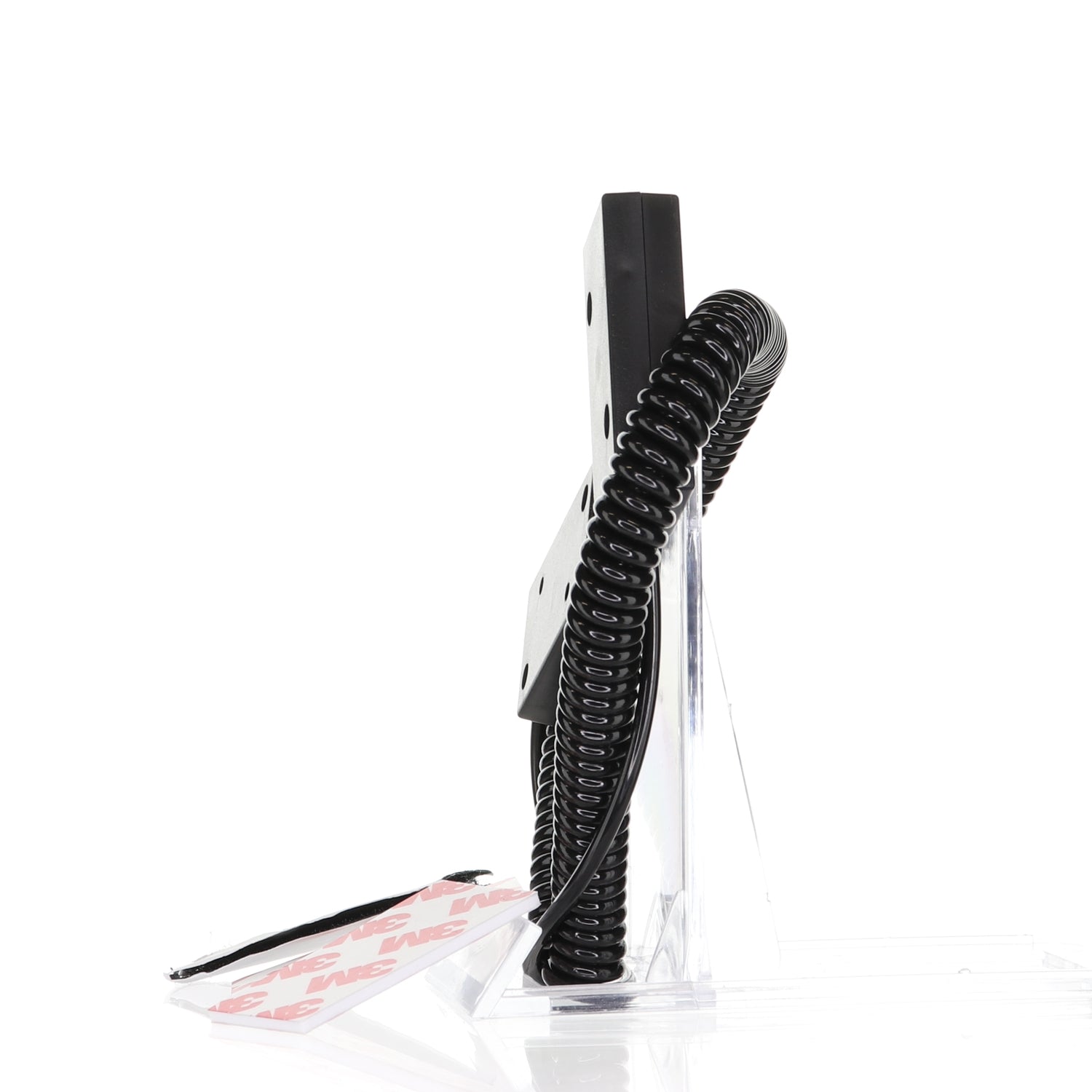 Side view of a black Anderic Universal Remote Control Security Cable Tether - CBL02, mounted on a transparent stand with adhesive strips for easy installation.
