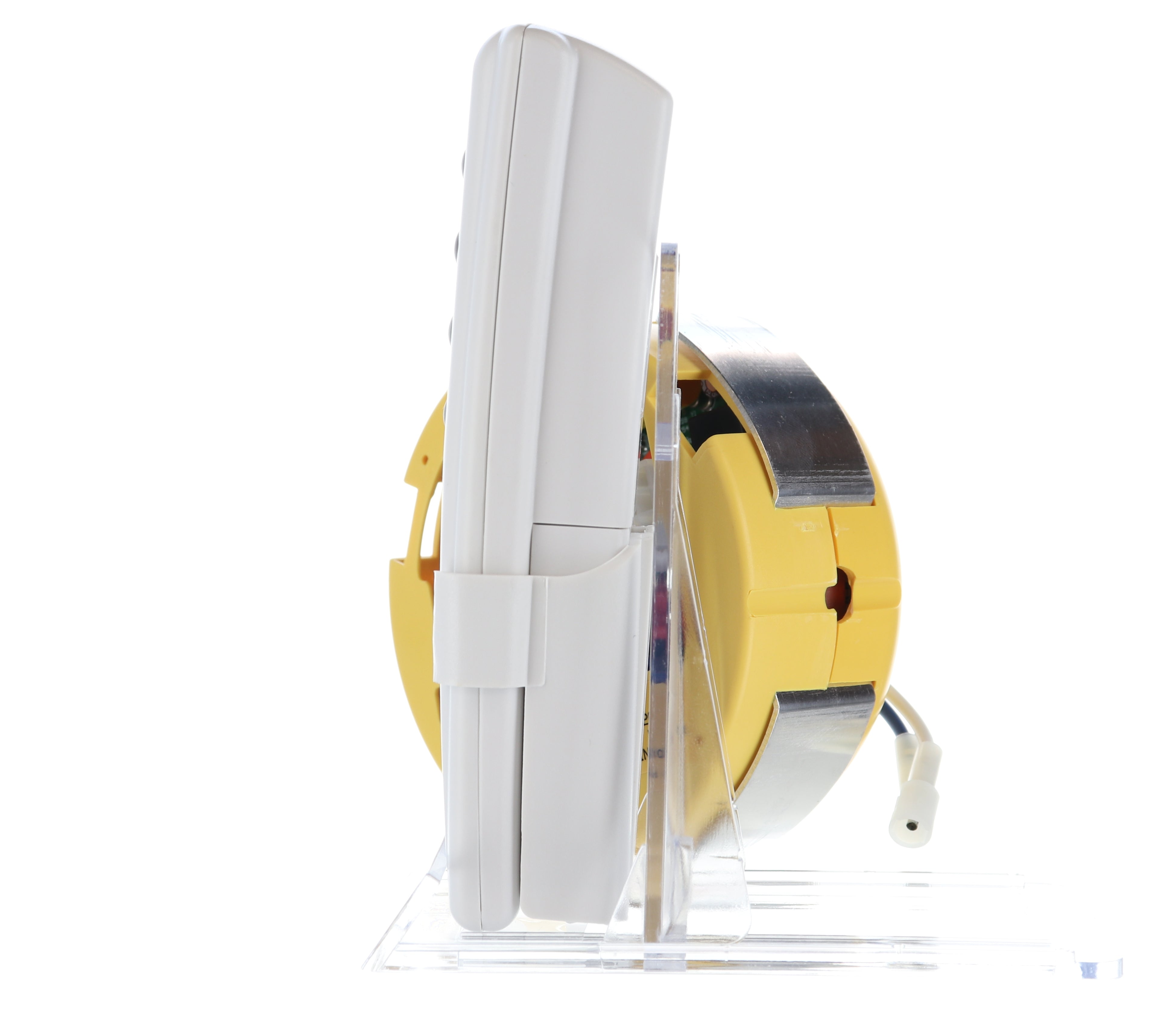 A white handheld device sits on a transparent stand, linked to a round yellow base with metal accents and a visible cable, echoing the design of the Anderic FAN2R/RR7078TR Kit for Hampton Bay/HUNTER ceiling fan remotes.