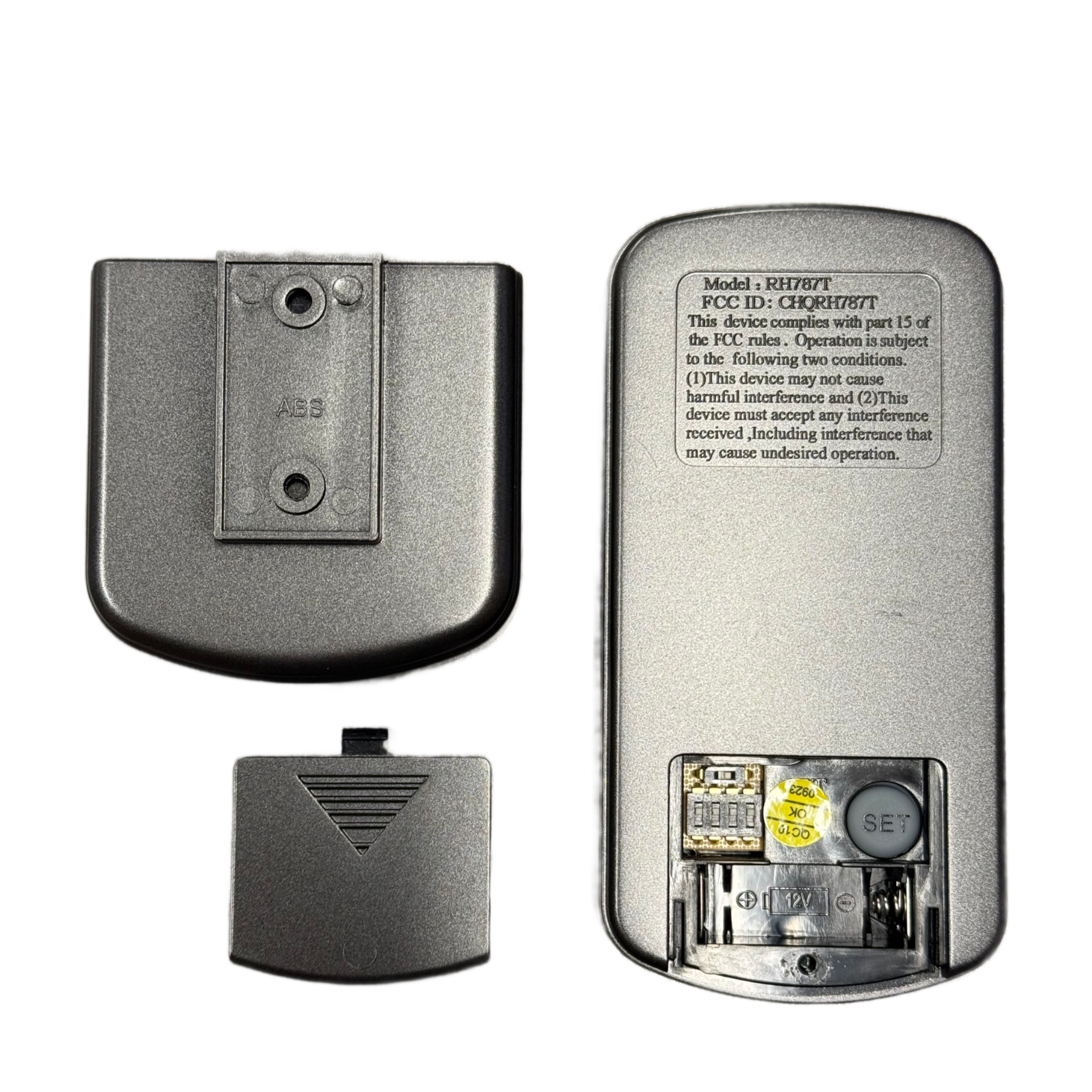 Back view of the Fanimation RH787T Gray Hand Held DC Motor Ceiling Fan Remote Control (TR29) with battery cover removed, showing the battery compartment, SET button, and speed settings. Battery cover and mounting bracket are placed beside it.