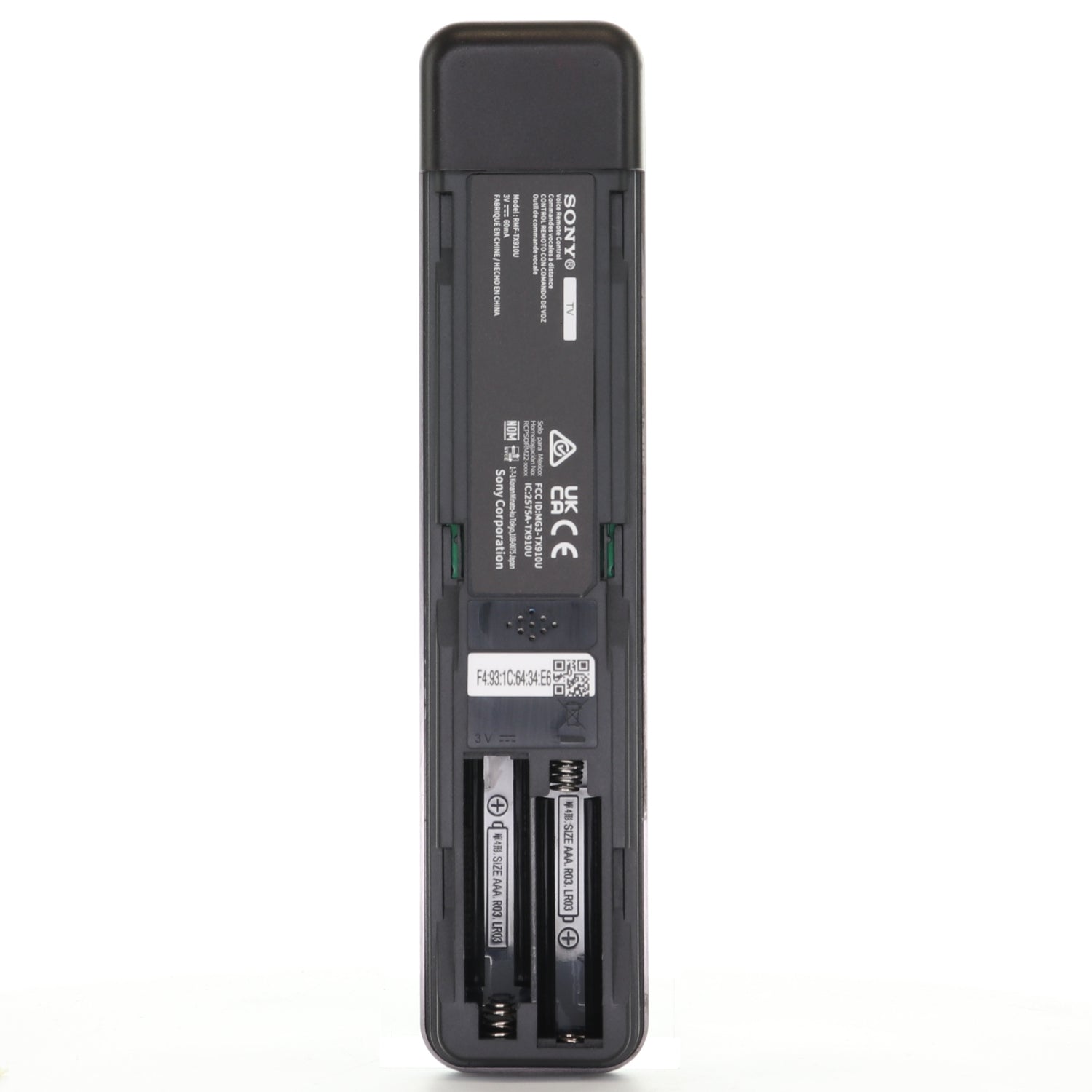 The image shows the back of the Sony RMF-TX910U Backlight Remote Control for BRAVIA XR/Master Series OLED 4K HDR Smart TVs, with its battery compartment open and slots for two AA batteries visible along with product labels.