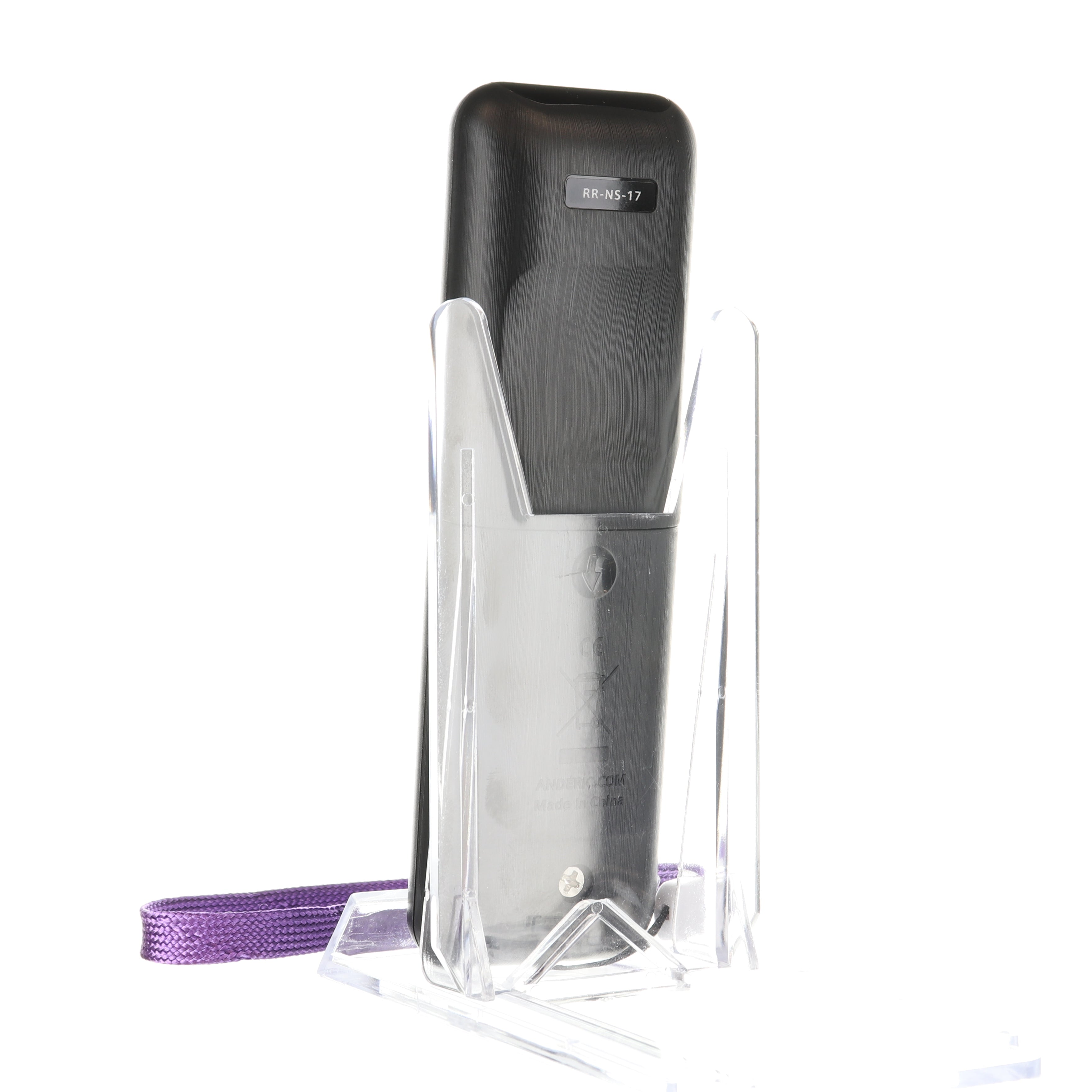 An Anderic RRNS17 for Insignia Roku Enhanced TV Remote Control, sleek and black, elegantly rests in a transparent stand, paired with a purple strap.