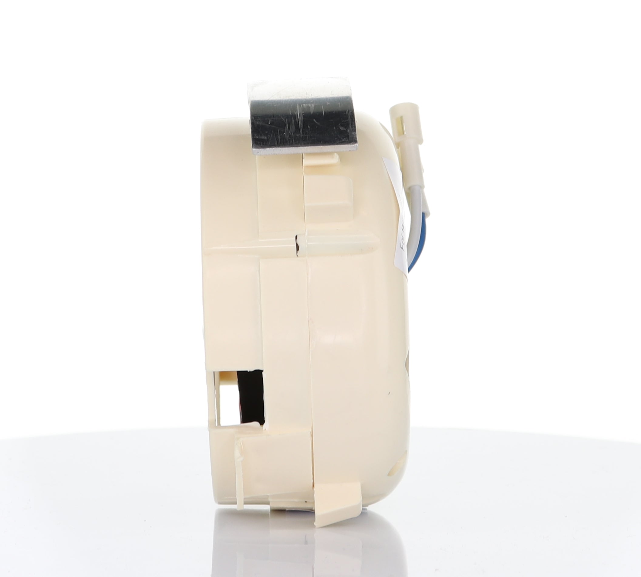 Side view of the Anderic UC7051R Replacement Ceiling Fan Receiver for 3-speed fans with reverse function, beige plastic body, connector, and blue wire, shown on a reflective white surface.