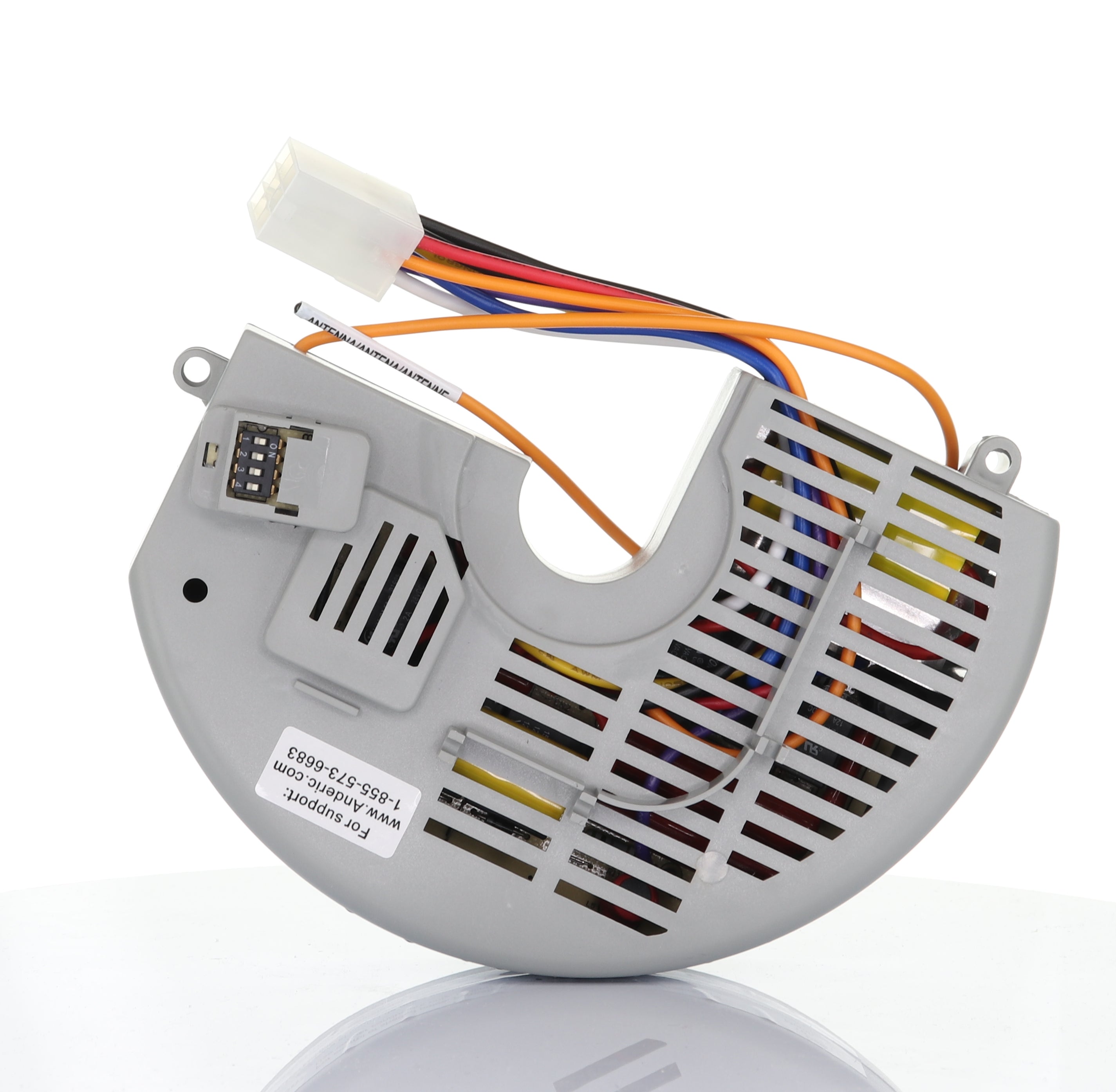 A semi-circular gray computer fan with multicolored wires and connectors, similar in sleek design to the Anderic FAN10R Replacement Ceiling Fan Receiver for Hampton Bay, is elegantly placed on a reflective surface.
