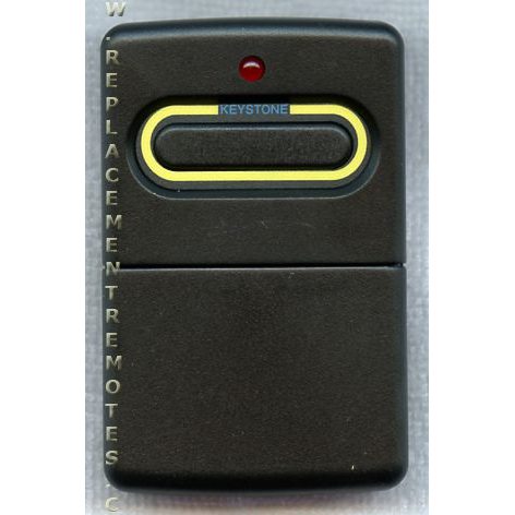 The Crusader 360MHz visor remote 0220360 features a black design with a yellow-bordered button and a small red indicator light at the top, labeled "Keystone.
