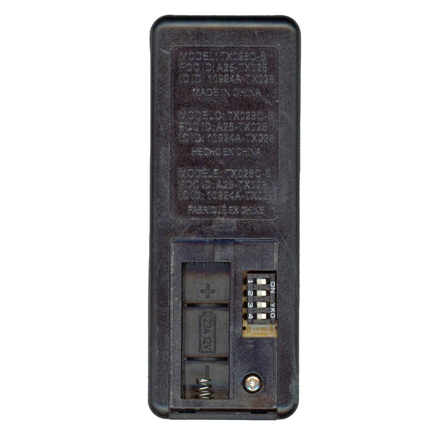 Back view of a black Hampton Bay TX028C-S Ceiling Fan Remote Control, showing the battery compartment and switches. Model and serial numbers are printed at the top, ideal for controlling your indoor-outdoor ambiance with color-changing LED settings.