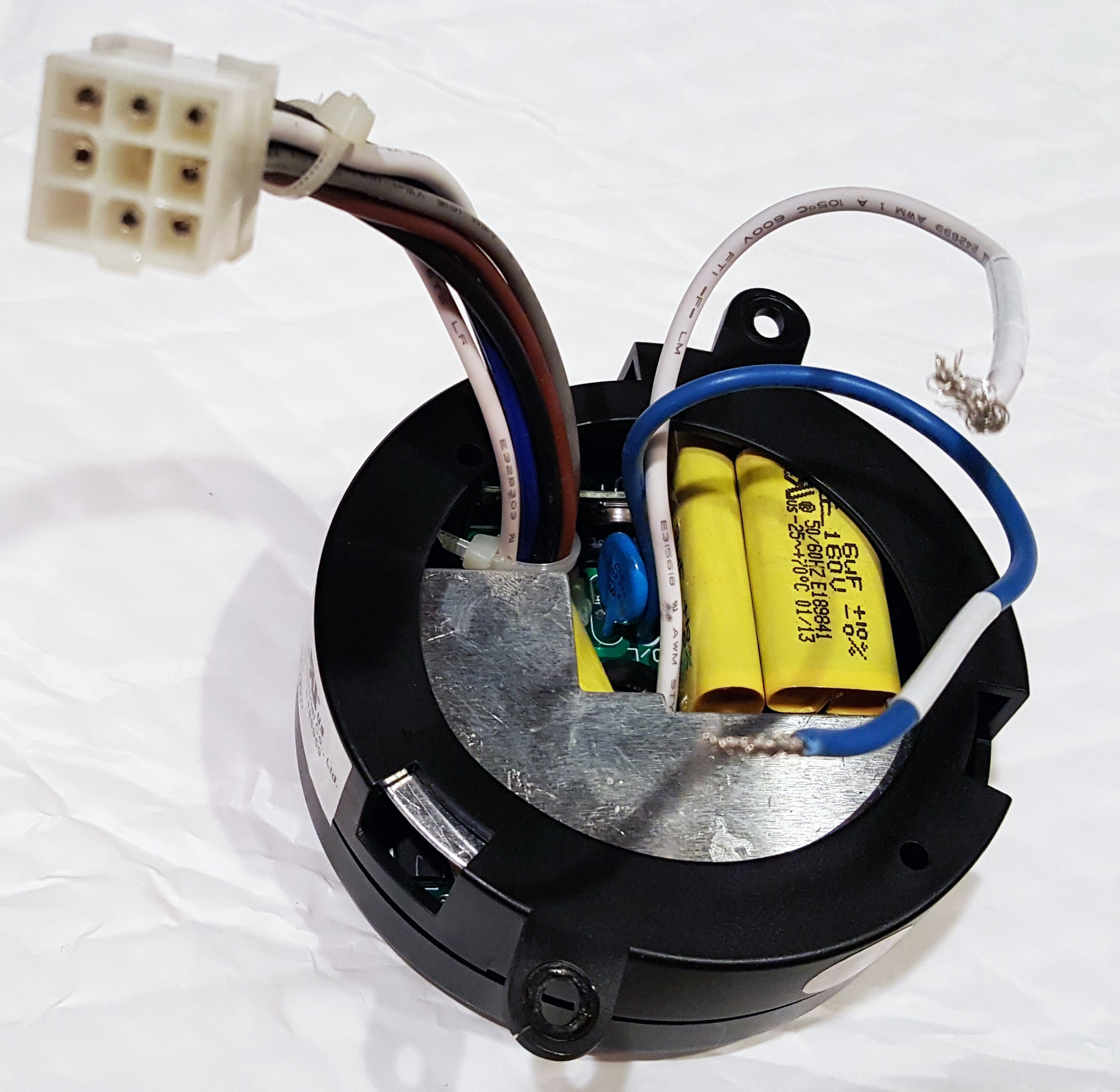 The Home Decorators Collection MR77A Ceiling Fan Remote Control Kit features a round electronic component with exposed wires, yellow capacitors, and a white connector plug on a black circular base—compatible with Altura ceiling fans.