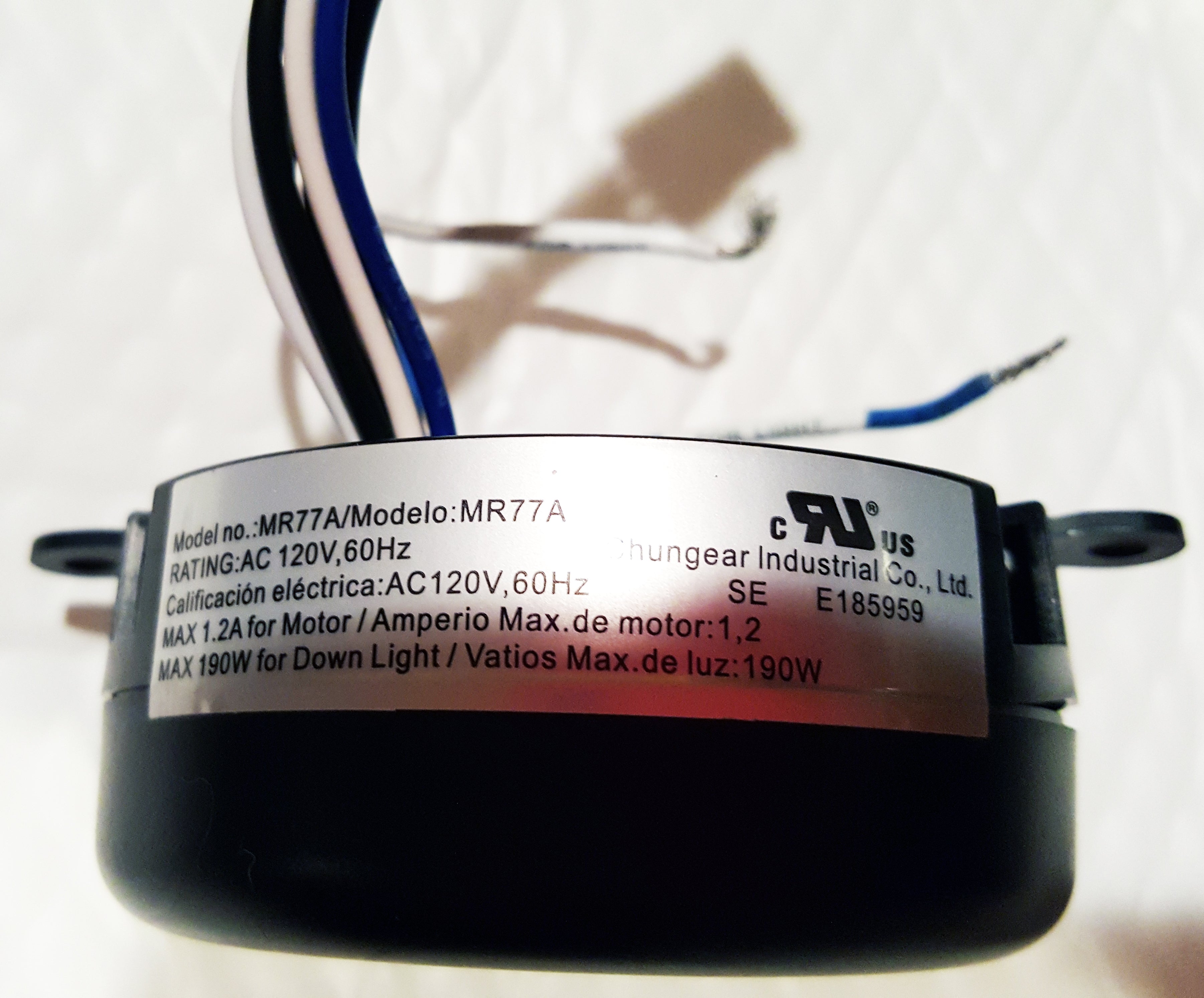 Close-up of a Home Decorators Collection MR77A Ceiling Fan Remote Control Kit label, displaying 120V 60Hz rating, max 1.2A motor, and 190W down light, with visible wires above the label.