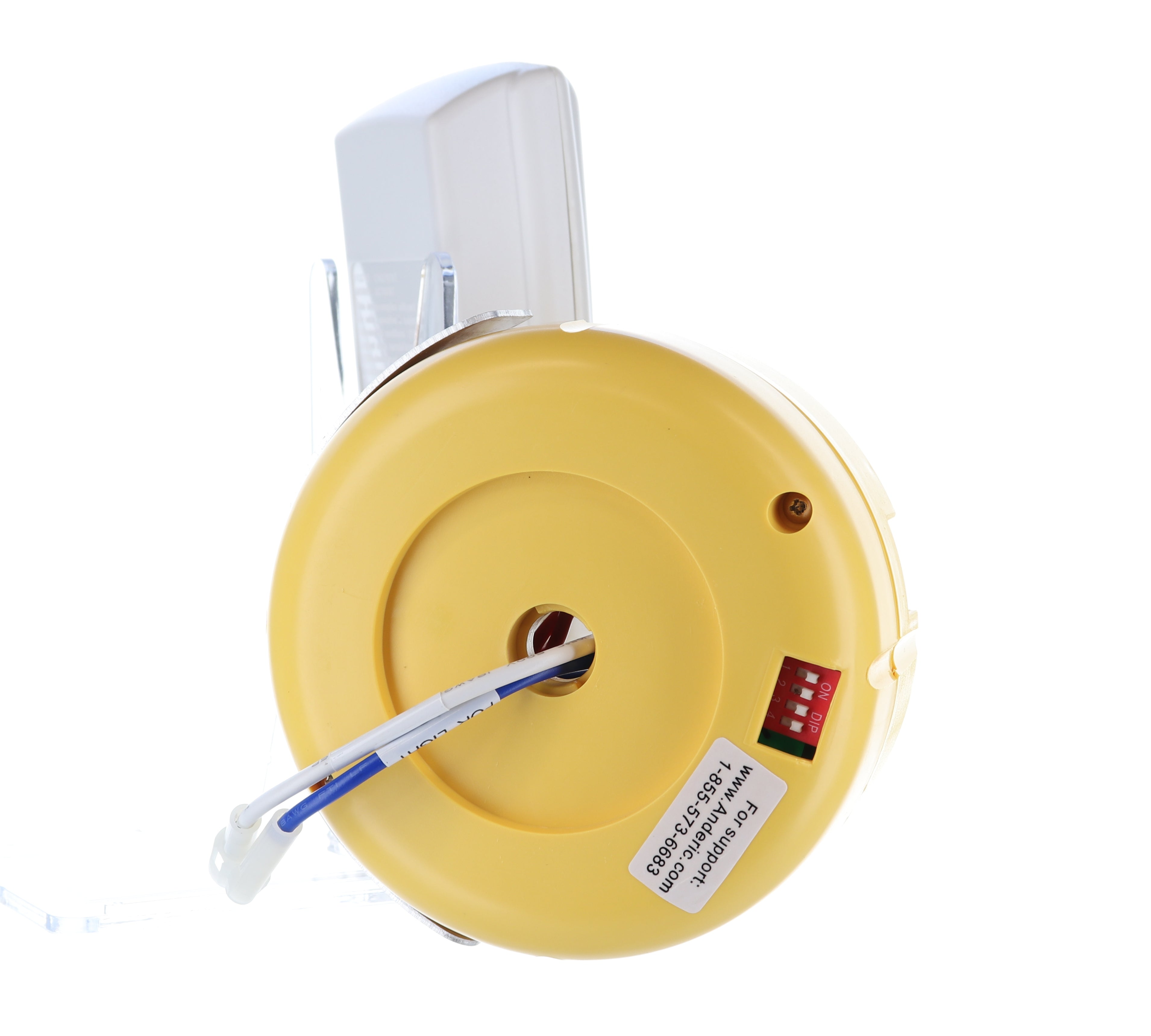 A yellow round electronic device with a white dial, red switch panel, and text label resembles the Anderic FAN2R/RR7078TR Remote Control Kit for Hampton Bay/HUNTER ceiling fans. It connects to a white wire and mounts on a transparent stand.