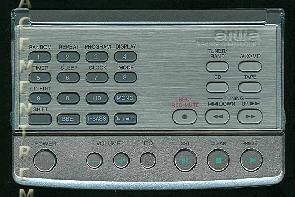 A close-up of an Aiwa RCAAT03 Audio Remote Control showcases gray buttons with black text labels for numeric, playback, and function keys.