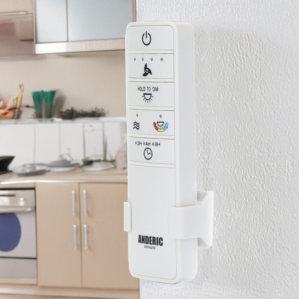 Anderic RRTR227B white ceiling fan remote control mounted on a wall bracket in a kitchen setting.