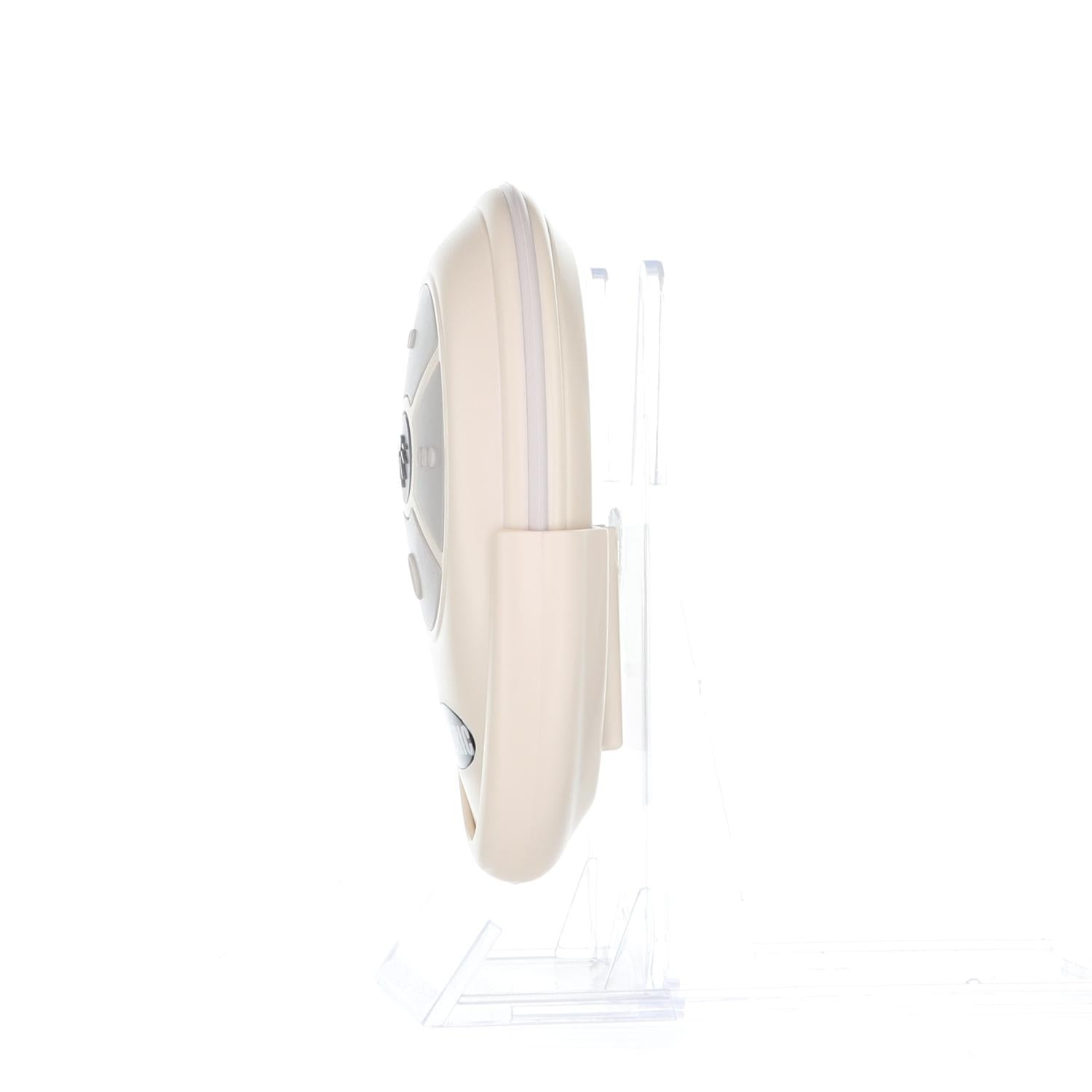 A side view of a round, beige electronic device resembling the Anderic RRTX007 for A25-TX007 Harbor Breeze Ceiling Fan Remote Control, with buttons, is mounted on a clear stand against a white background.